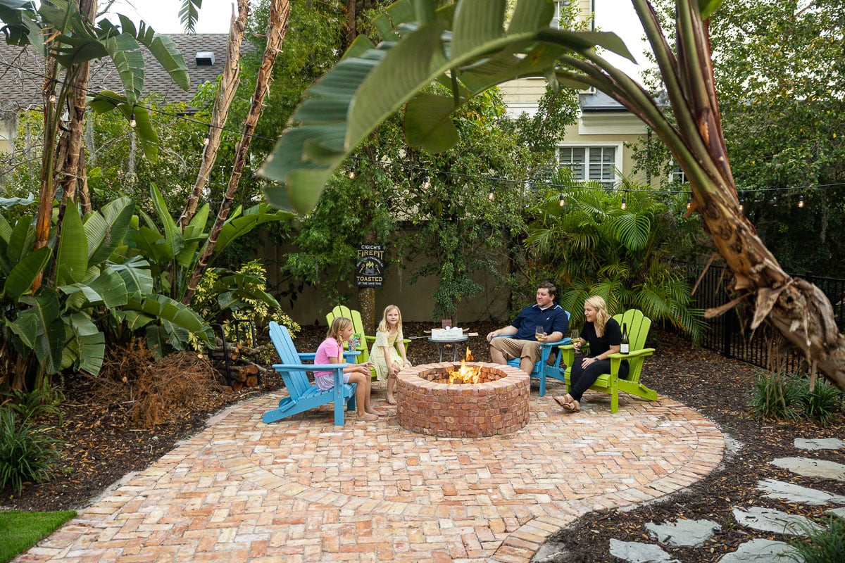 family enjoying fire pit in backyard