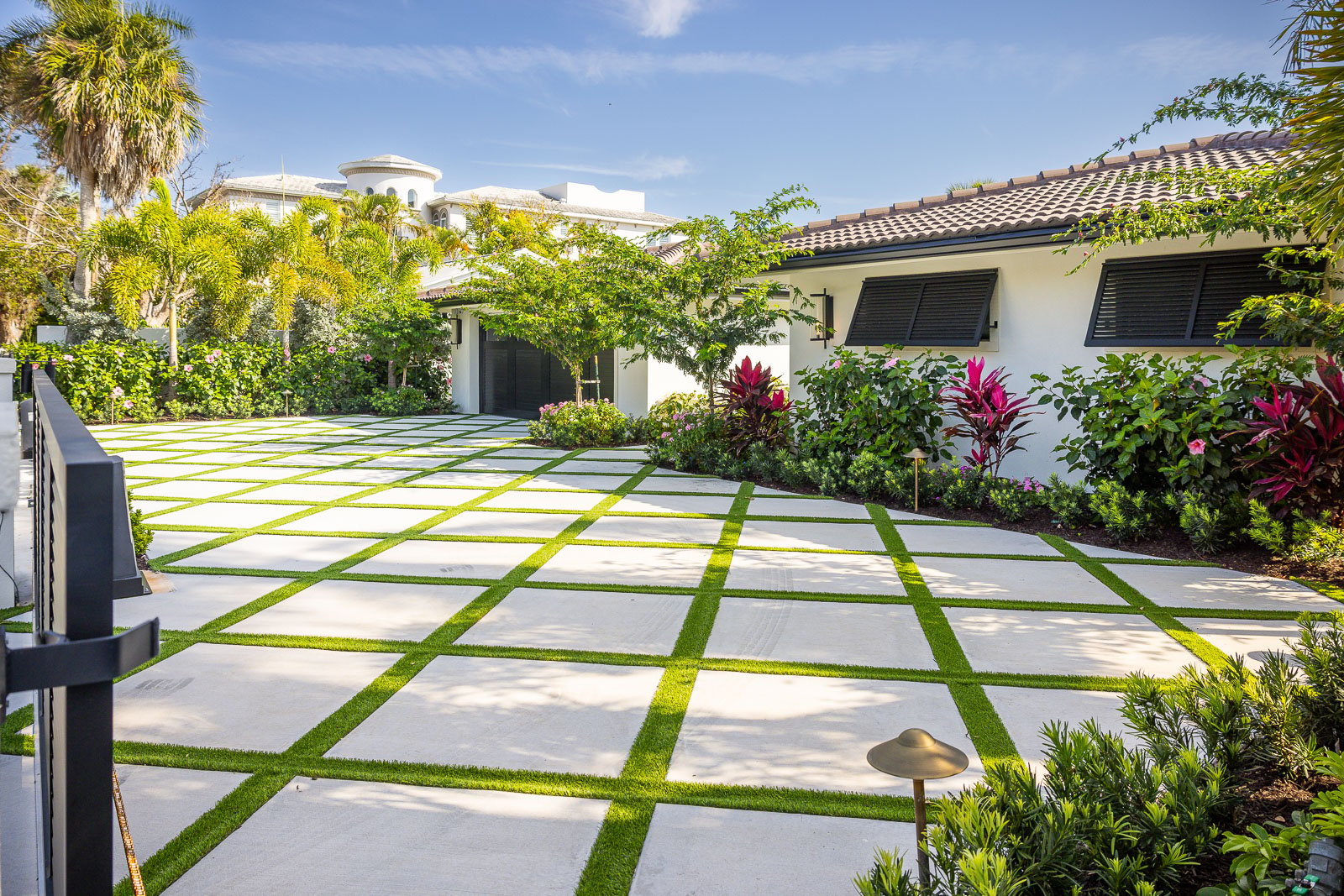 concrete poured pavers with artificial turf driveway