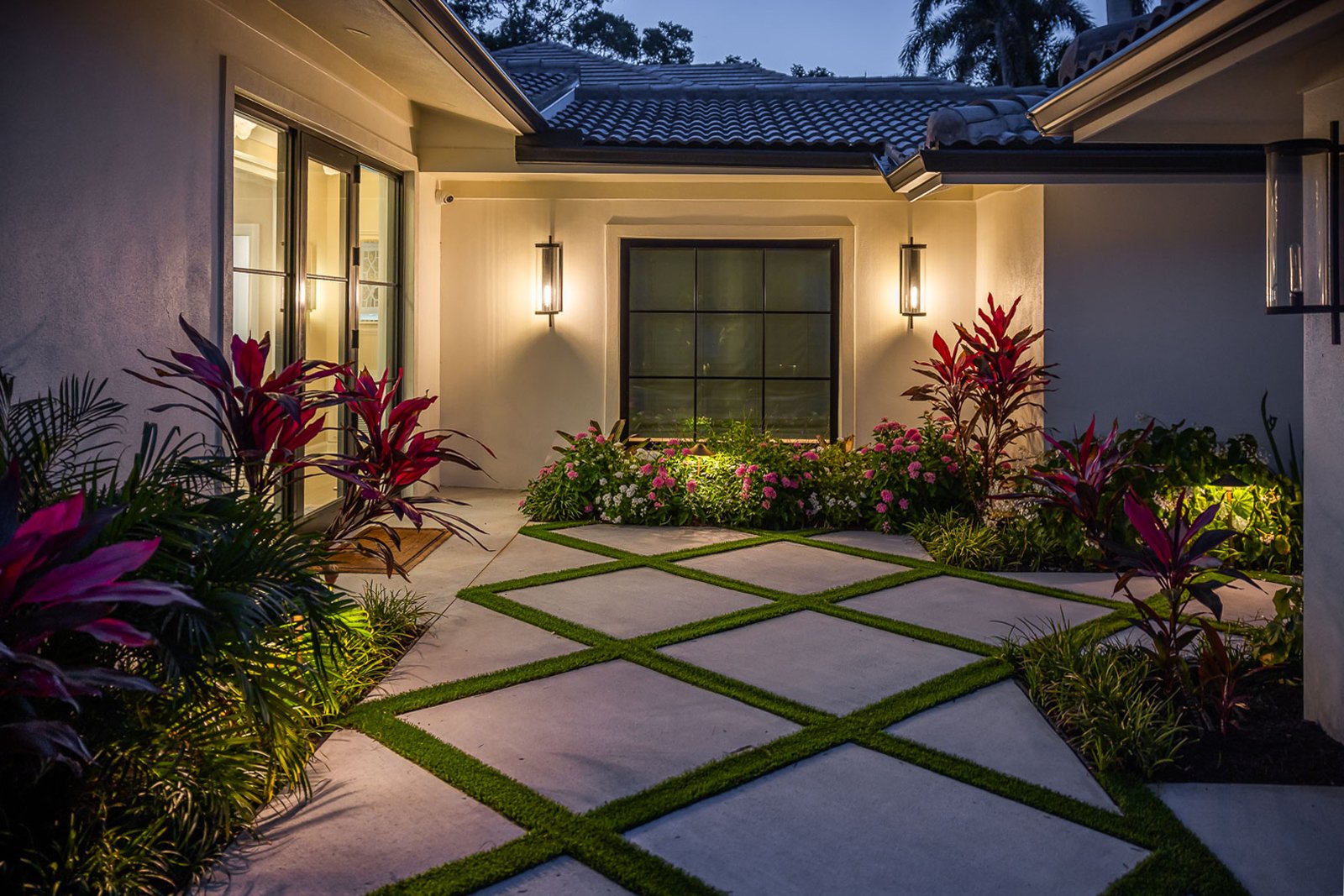 landscape lighting on house and in garden beds