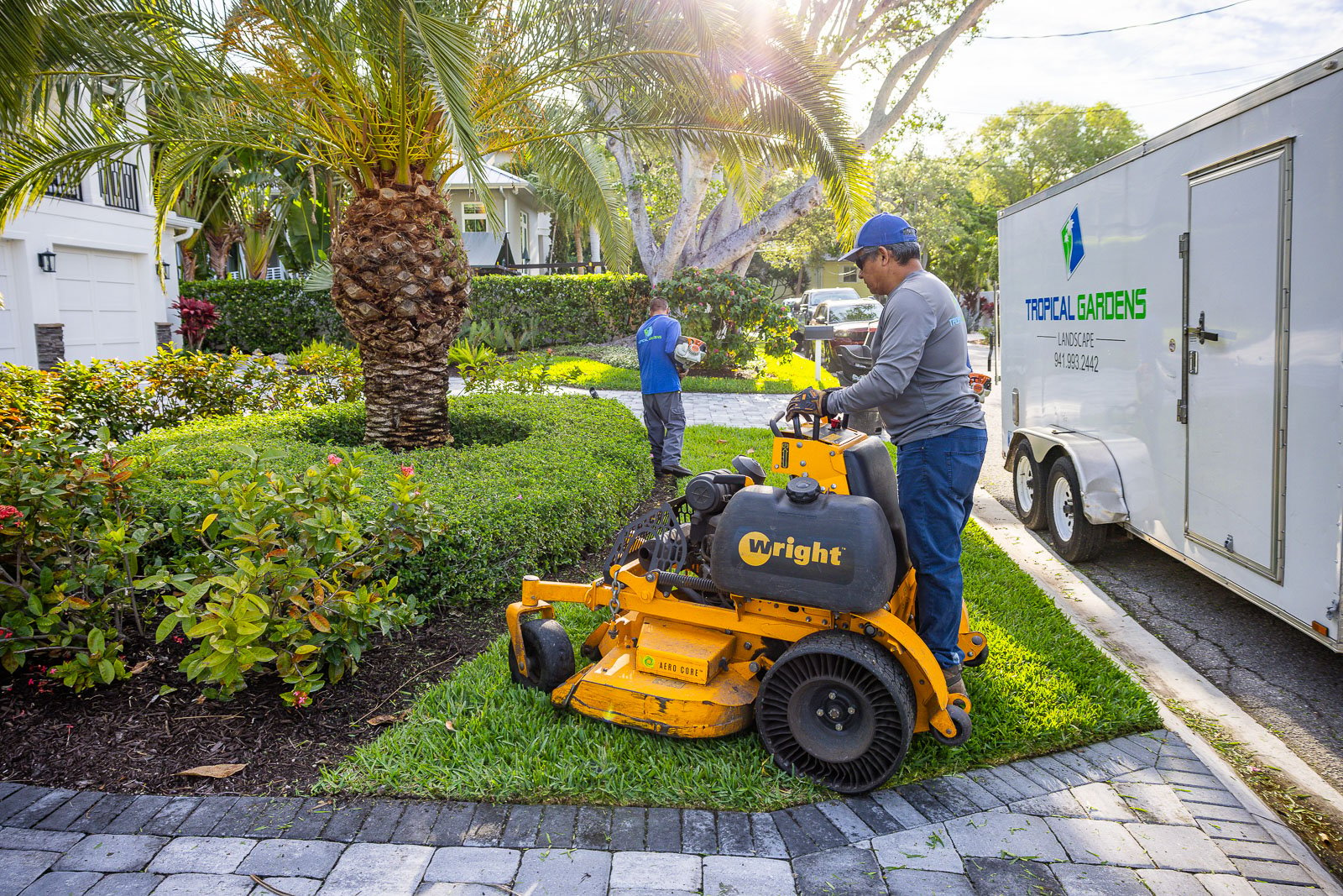 landscape maintenance crew mowing in yard