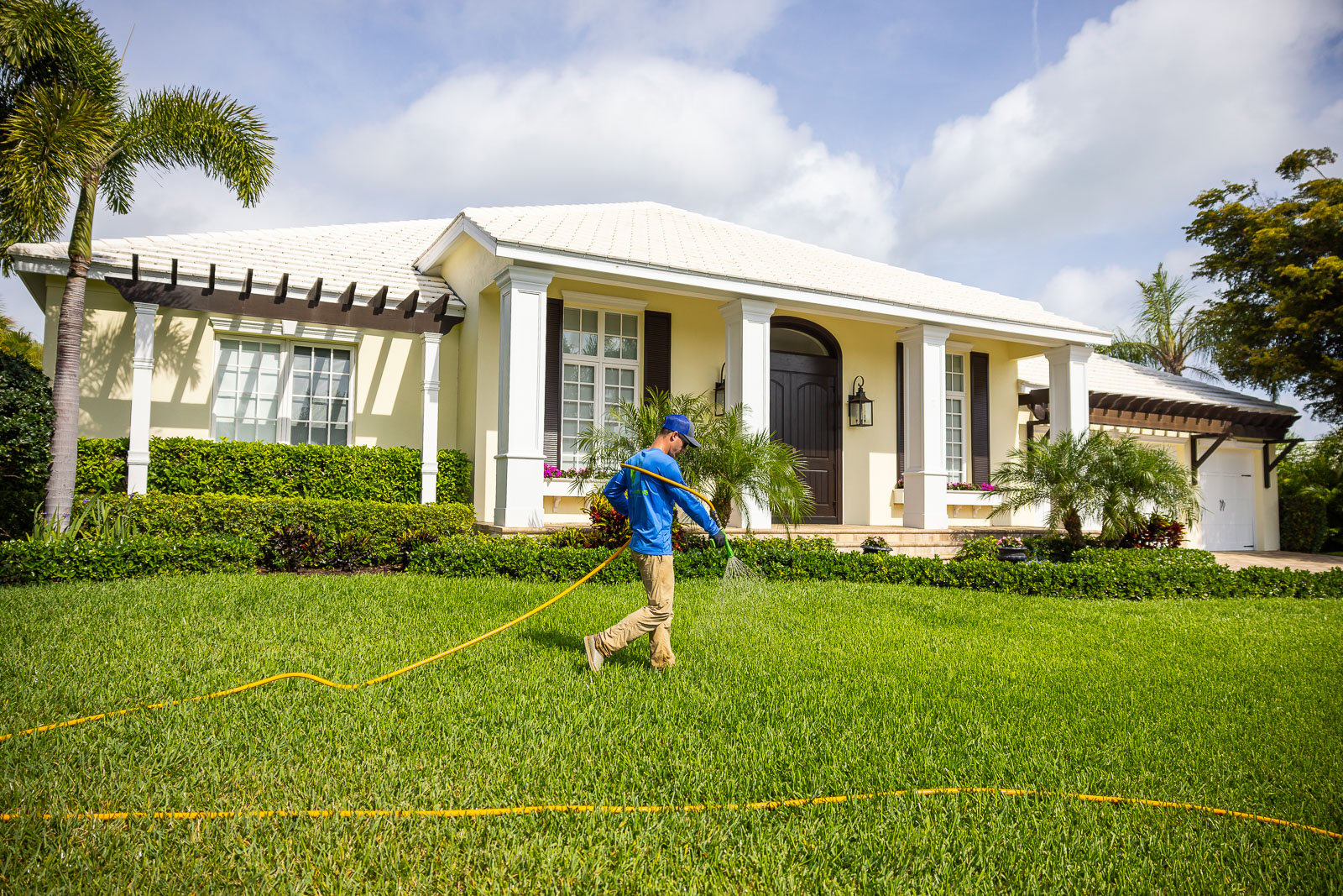 lawn care crew spraying lawn with weed control