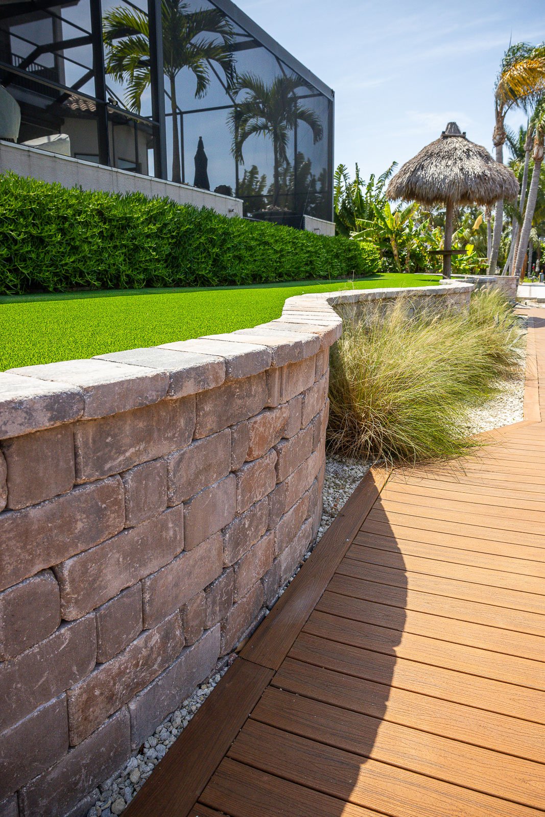 retaining wall with artificial turf and tiki umbrella 