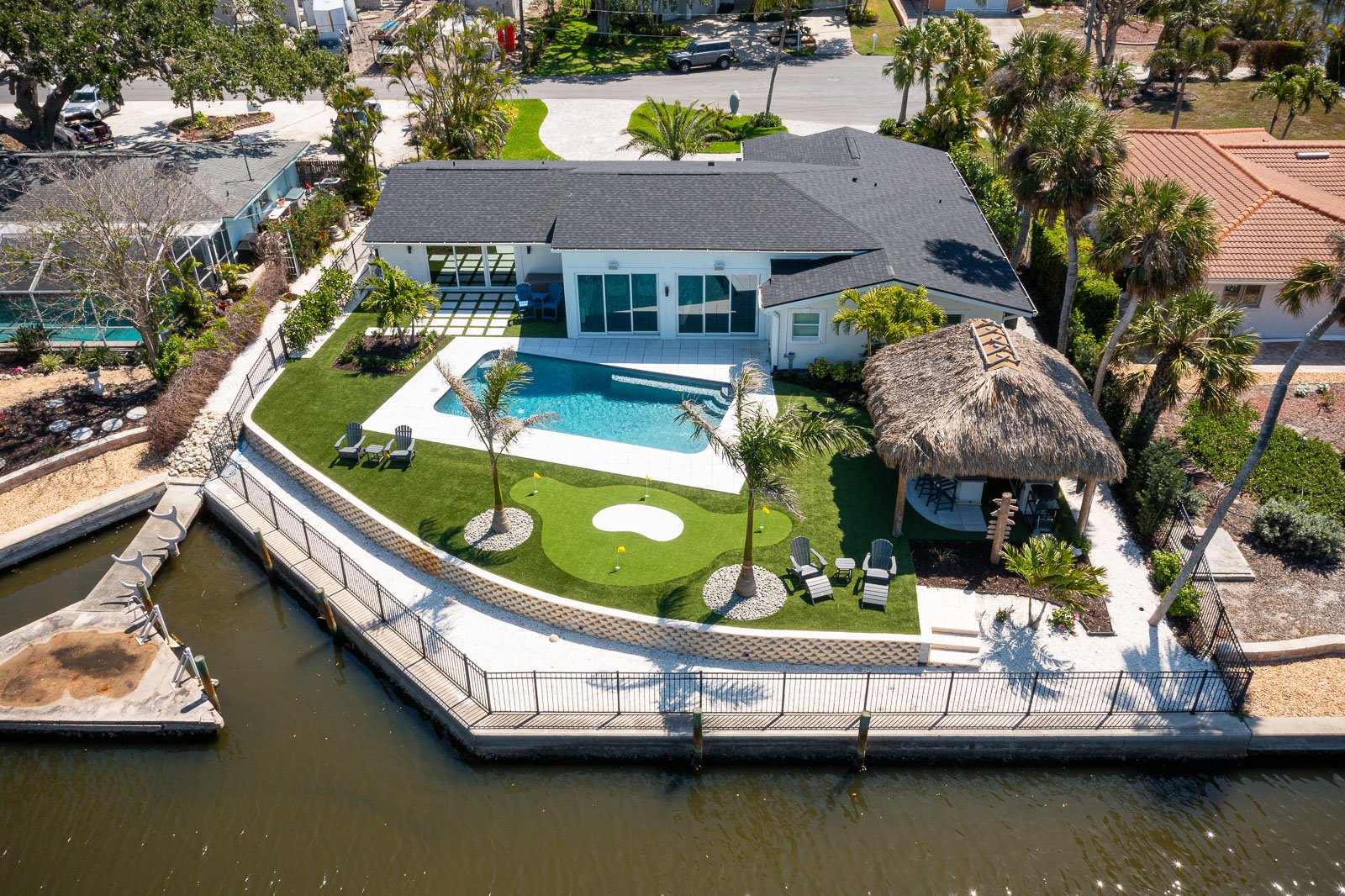 back of house aerial view landscape beds putting course pool tiki hut