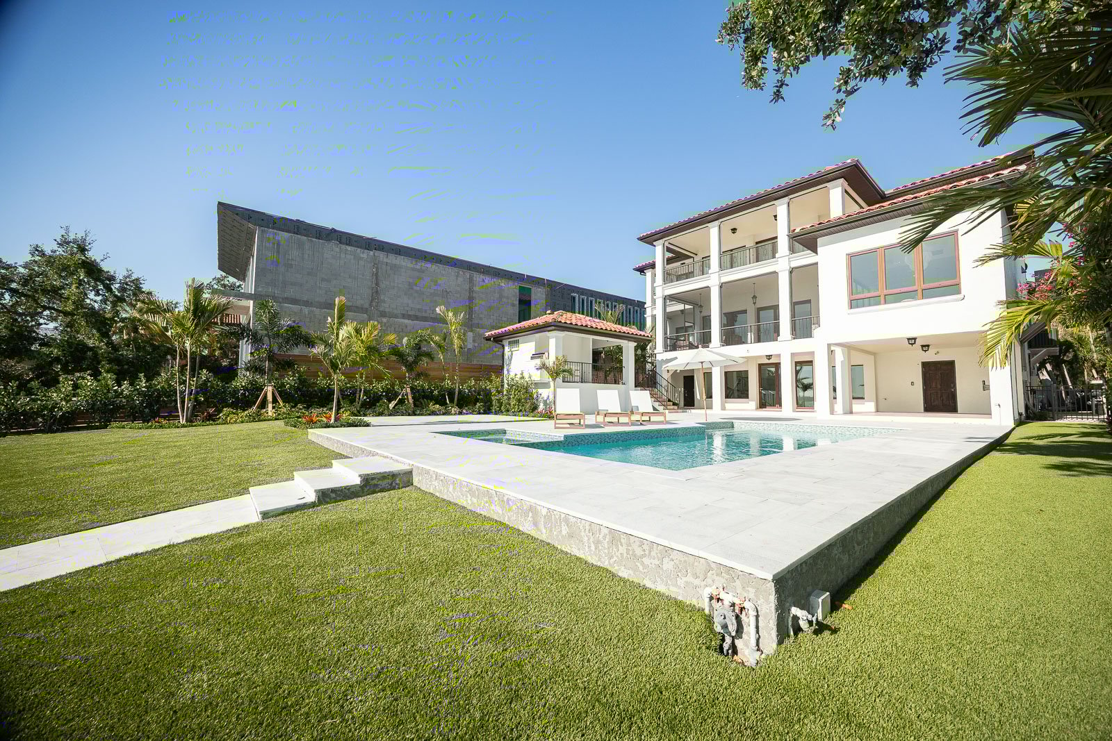 backyard patio outdoor seating pool landscape beds artificial turf 5