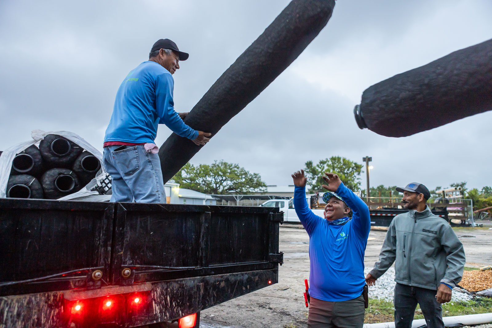 crew unloading turf from truck 