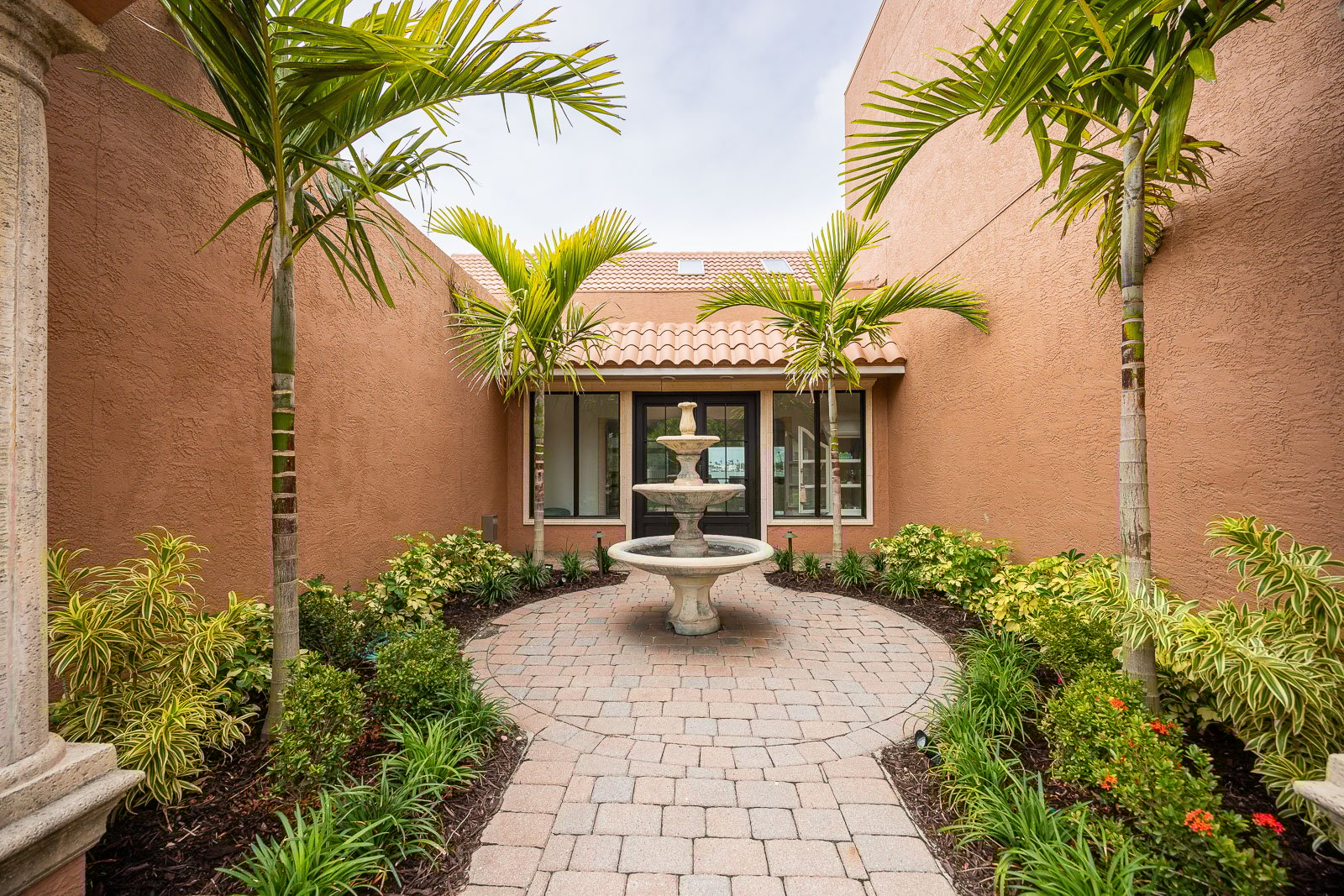 water fountain in patio surrounded by plants