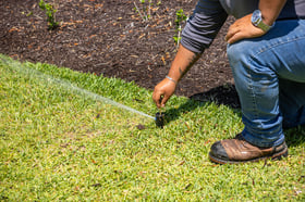 irrigtaion technician inspecting system 9