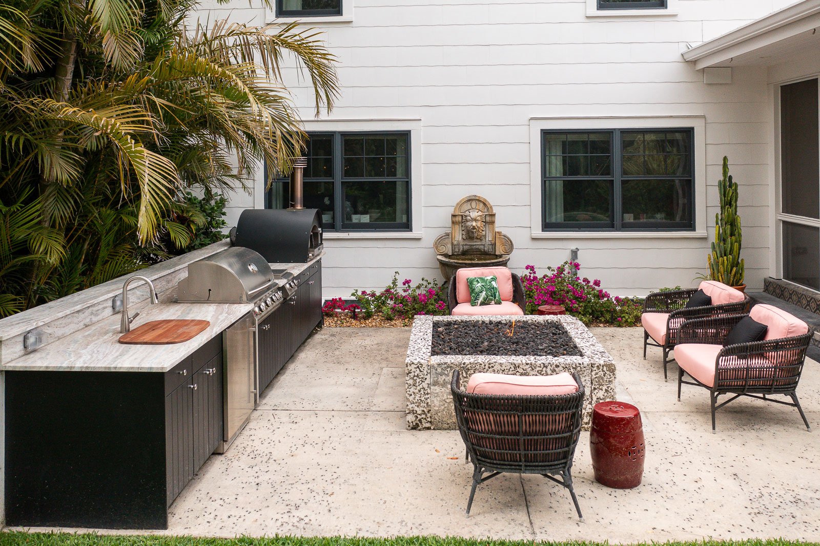 outdoor kitchen with firepit seating patio water feature 