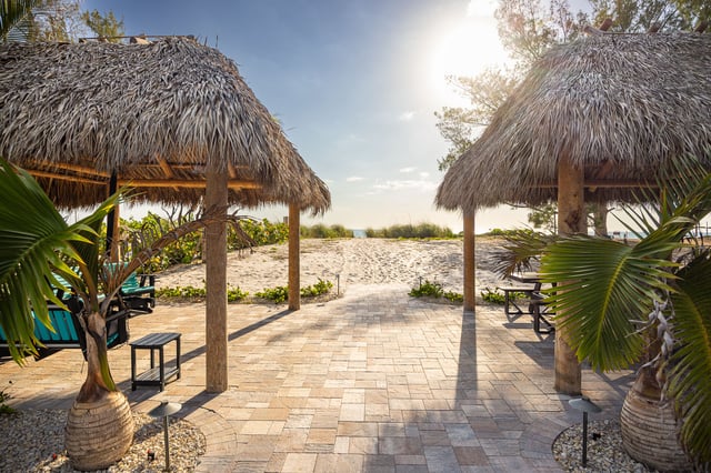 paver patio tiki huts leading to ocean