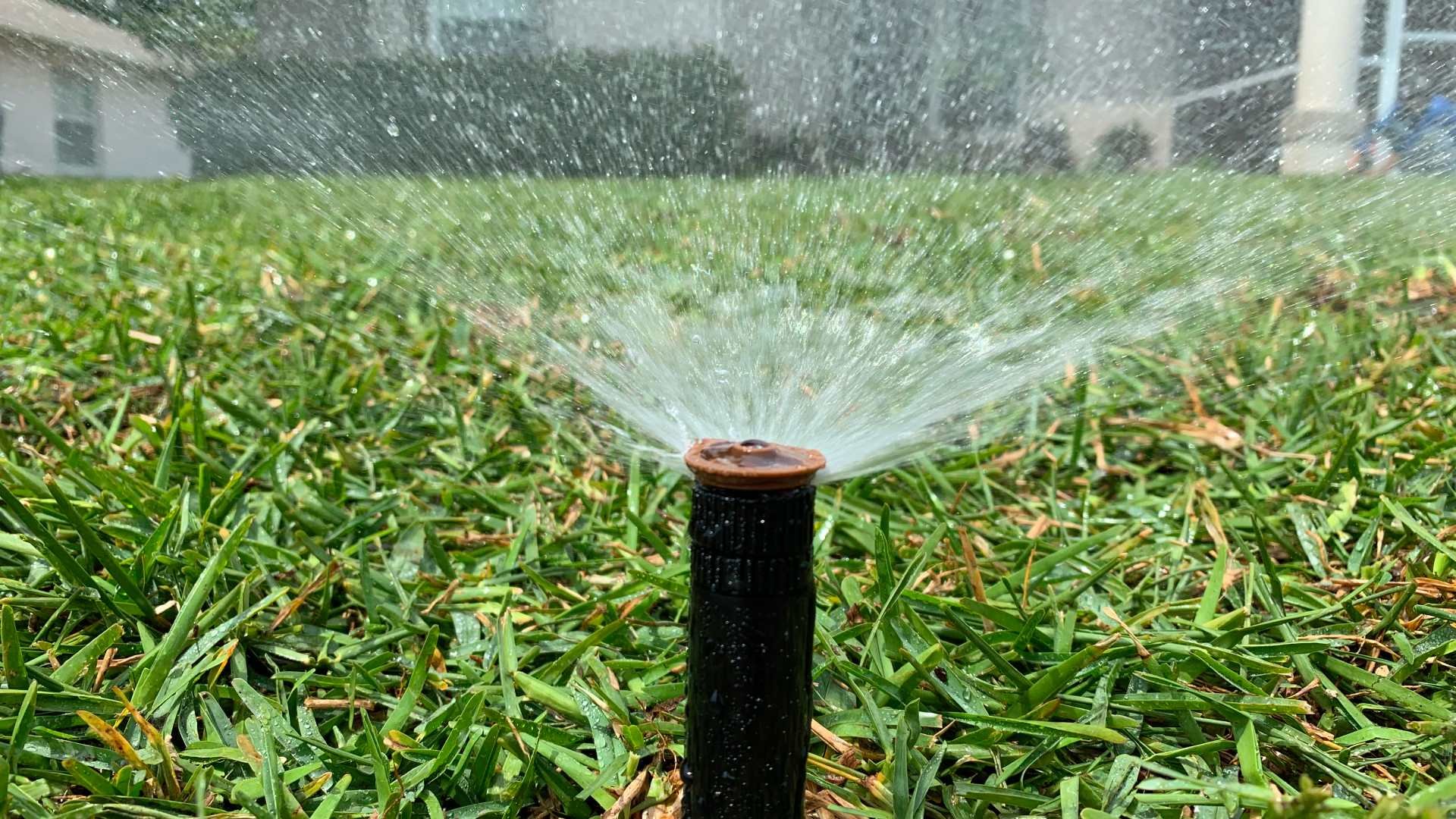 banner-sprinkler-system-watering-dull-lawn