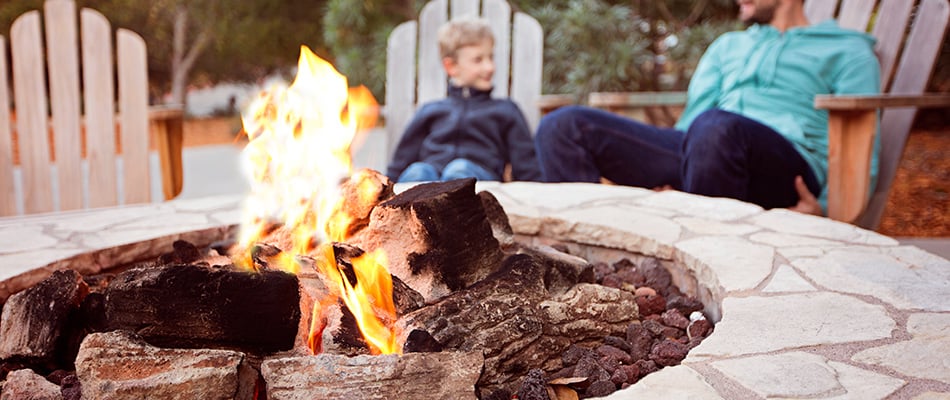content-people-enjoying-warmth-from-fire-pit