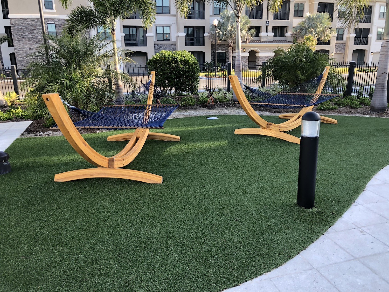 commerciallandscape design green artificial turf and hammocks