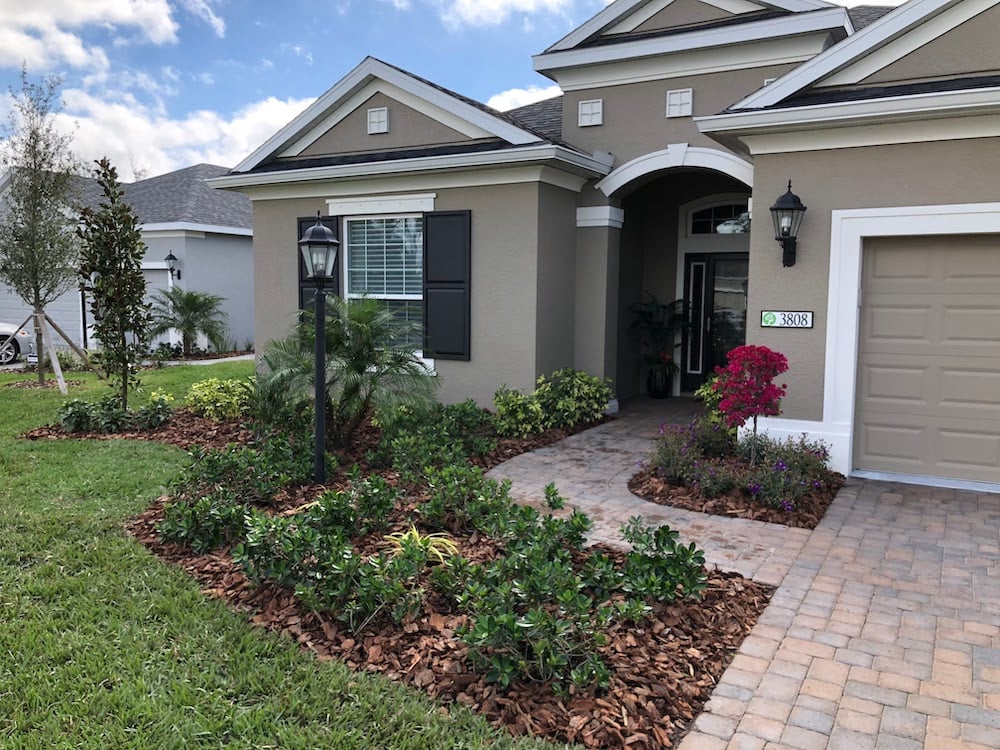 front of house with landscape beds next to walkway and driveway