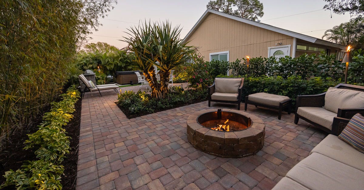 backyard patio with fire pit and outdoor lighting 