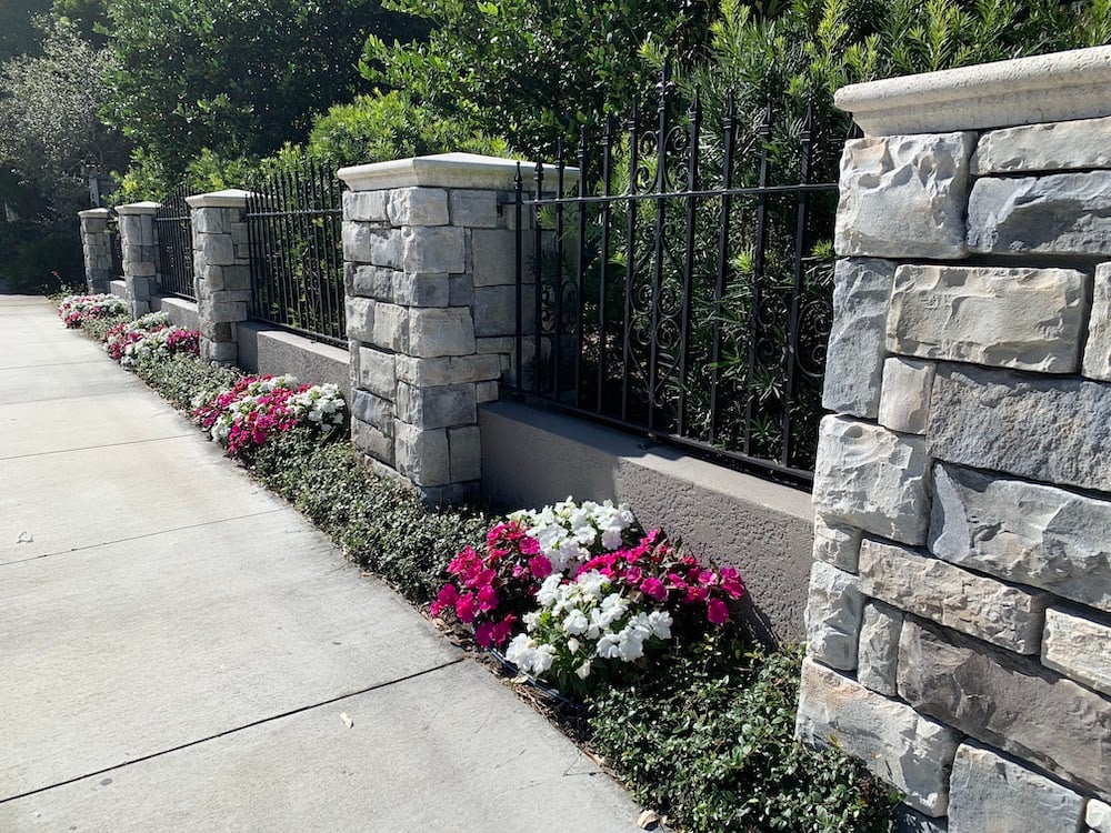 stone fence with planting beds