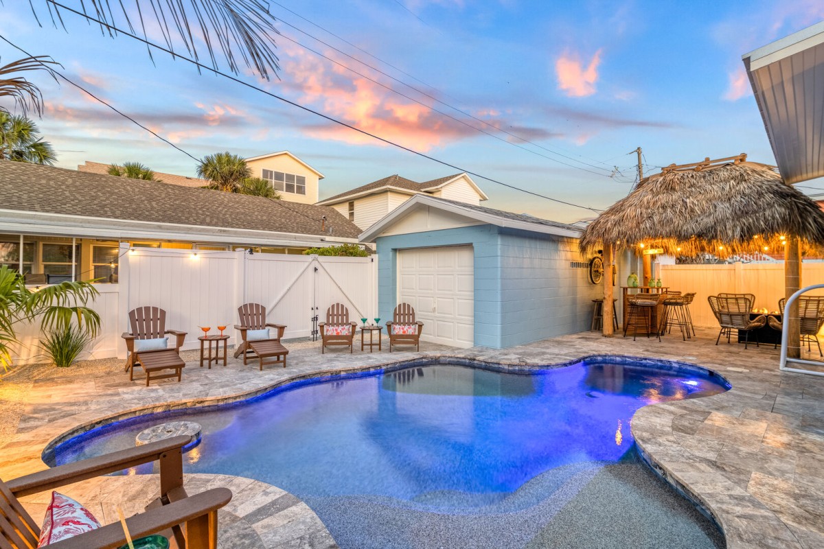tiki hut by pool at dusk with lighting