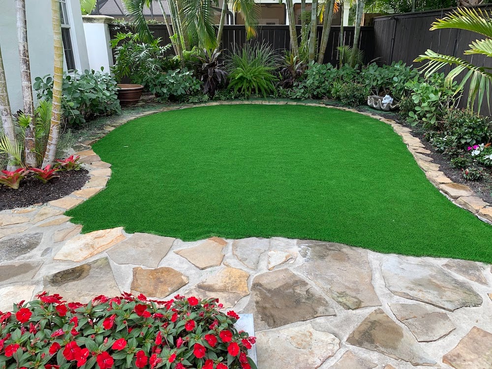 turf in small backyard with paver patio