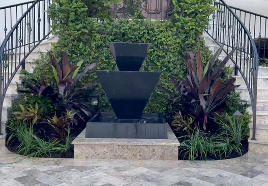 water feature in front of plants