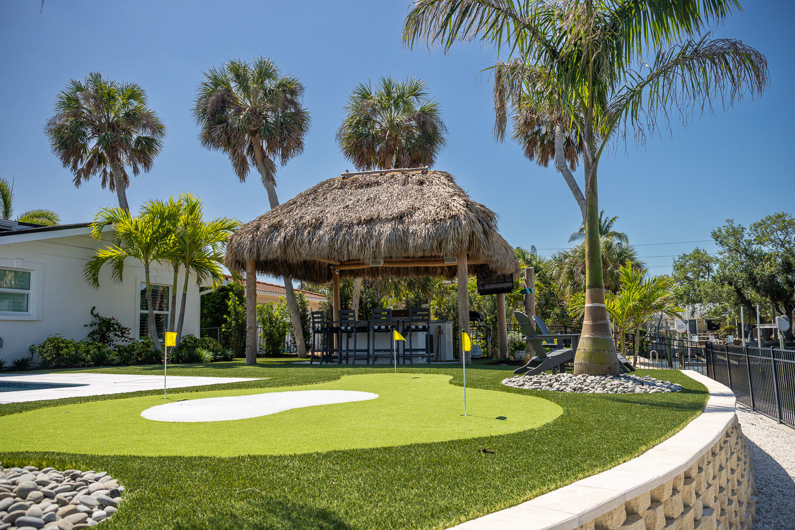 artificial turf putting green backyard retaining wall tiki hut 6