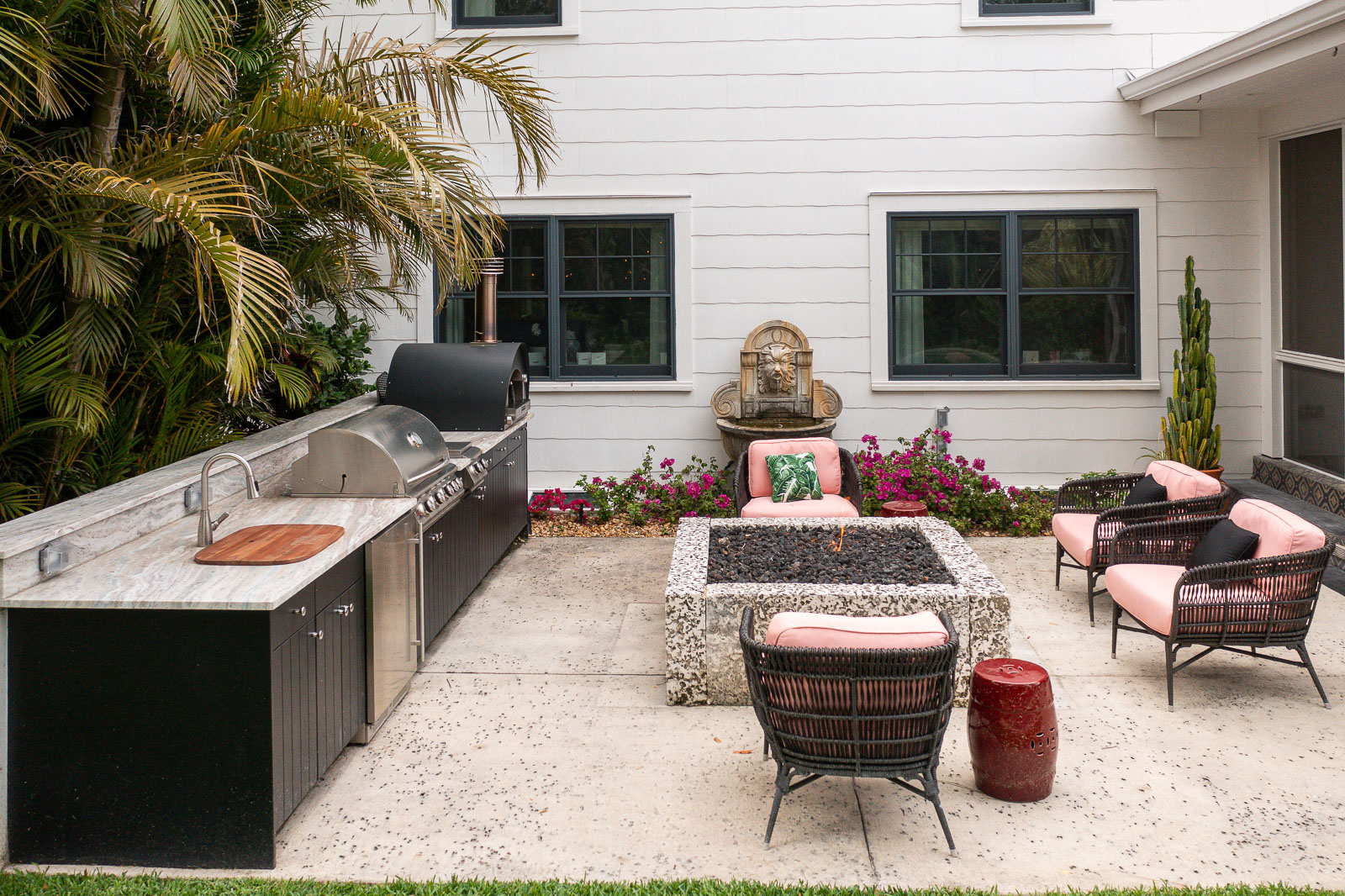 outdoor kitchen with firepit seating patio water feature 