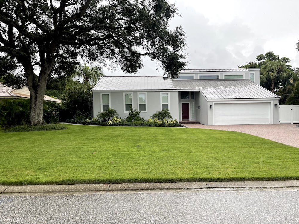 Front yard of house with green grass 