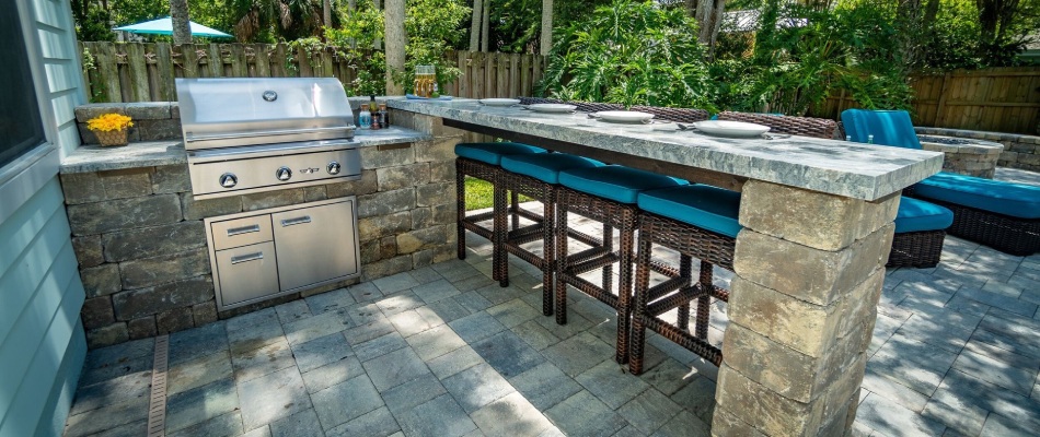 Custom built outdoor kitchen that includes a bar area in Siesta Key, FL.