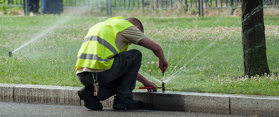 Irrigation tech testing a sprinkler in lawn in Sarasota, FL.