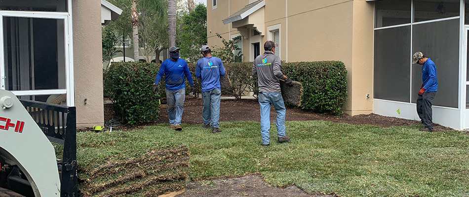 Tropical Gardens professionals servicing lawn in Palmetto, FL.