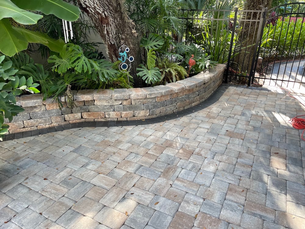 paver patio with entrance gate and lawn ornaments 