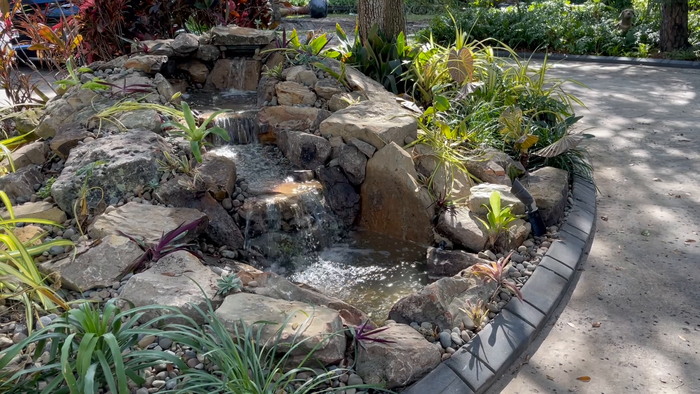 water feature along driveway with waterfall 